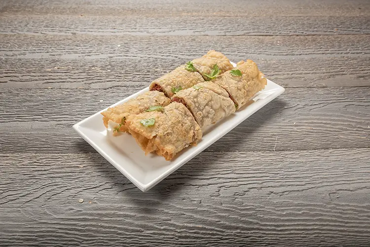 Crispy fried meat rolls garnished with cilantro at P P Pop Taiwanese Noodle Restaurant, a Taiwanese Restaurant in Monterey Park