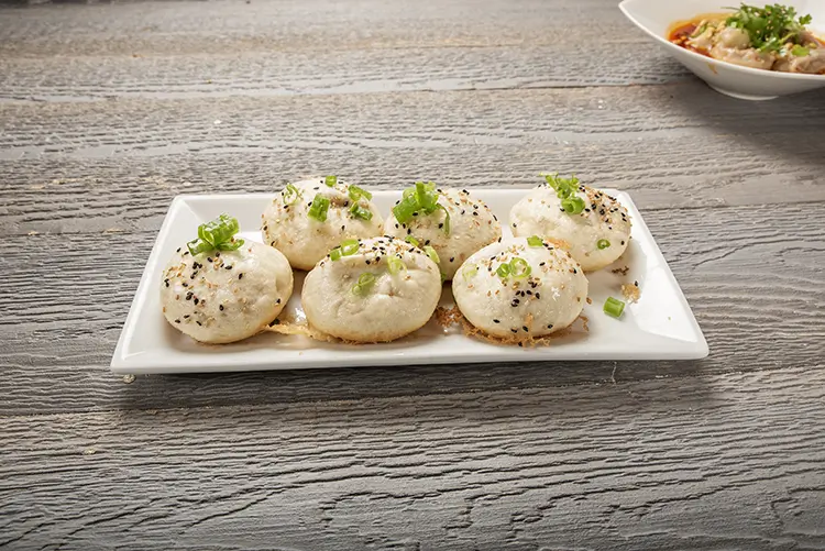 Pan‑fried buns topped with black sesame and green onions at P P Pop Taiwanese Noodle Restaurant, a Taiwanese Restaurant in Monterey Park