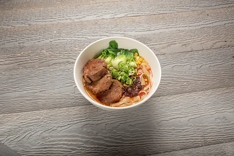 Spicy beef wide rice noodles with bok choy and corn at P P Pop Taiwanese Noodle Restaurant, a Taiwanese Restaurant in Monterey Park