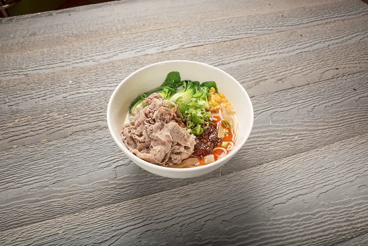 Spicy fatty beef wide rice noodles with bok choy and corn at P P Pop Taiwanese Noodle Restaurant, a Taiwanese Restaurant in Monterey Park